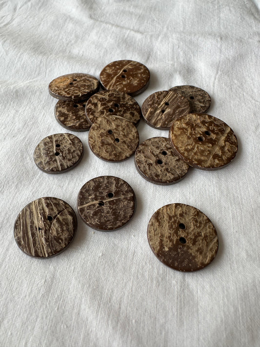 Kuvassa on ruskeita kookosnappeja (button).