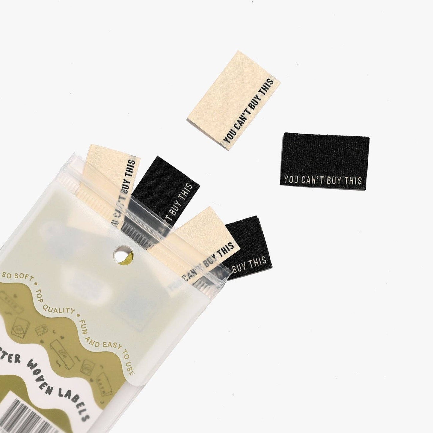 Kuvassa on Kylie & The Machine -kangasmerkit (labels) tekstillä You can't buy this.