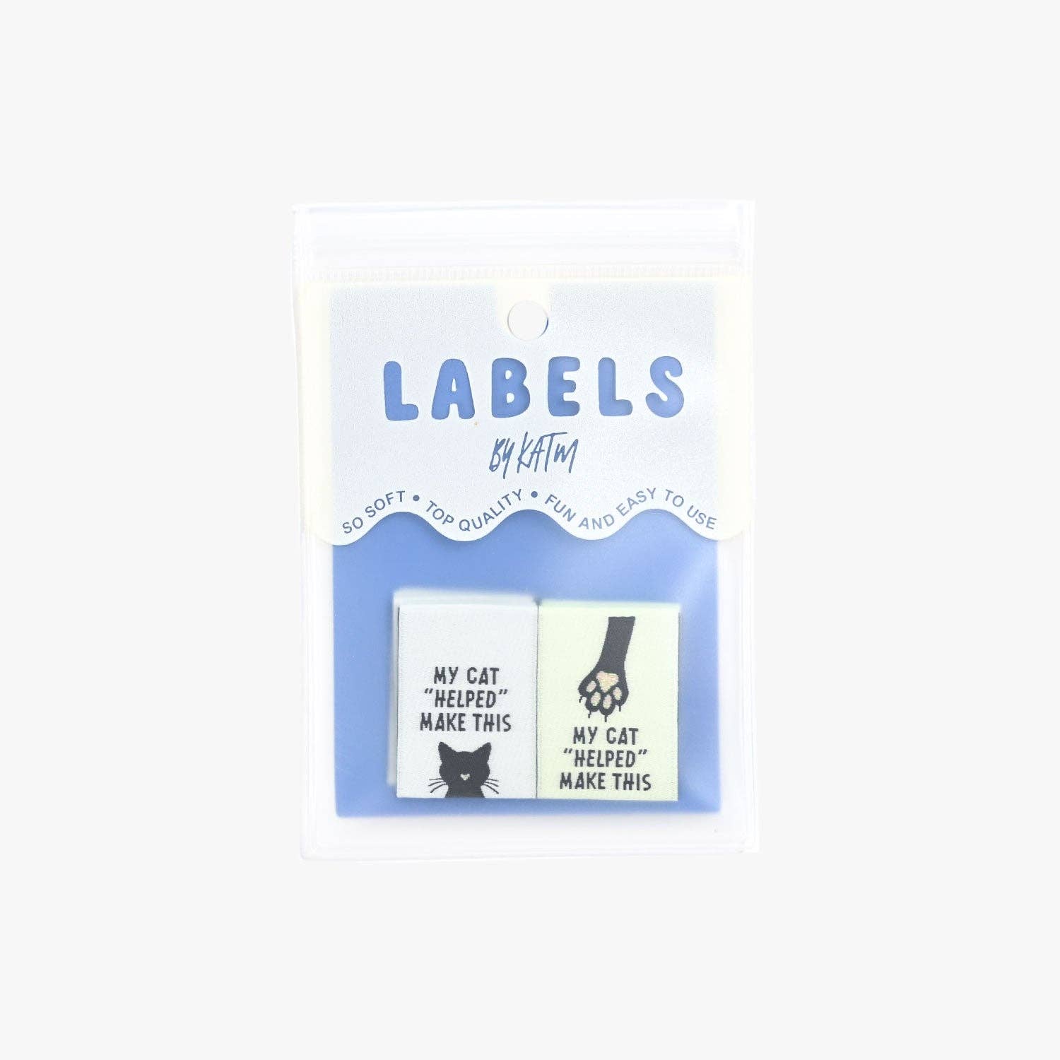 Kuvassa on Kylie & The Machine -kangasmerkit (labels) tekstillä My cat "helped" me make this.