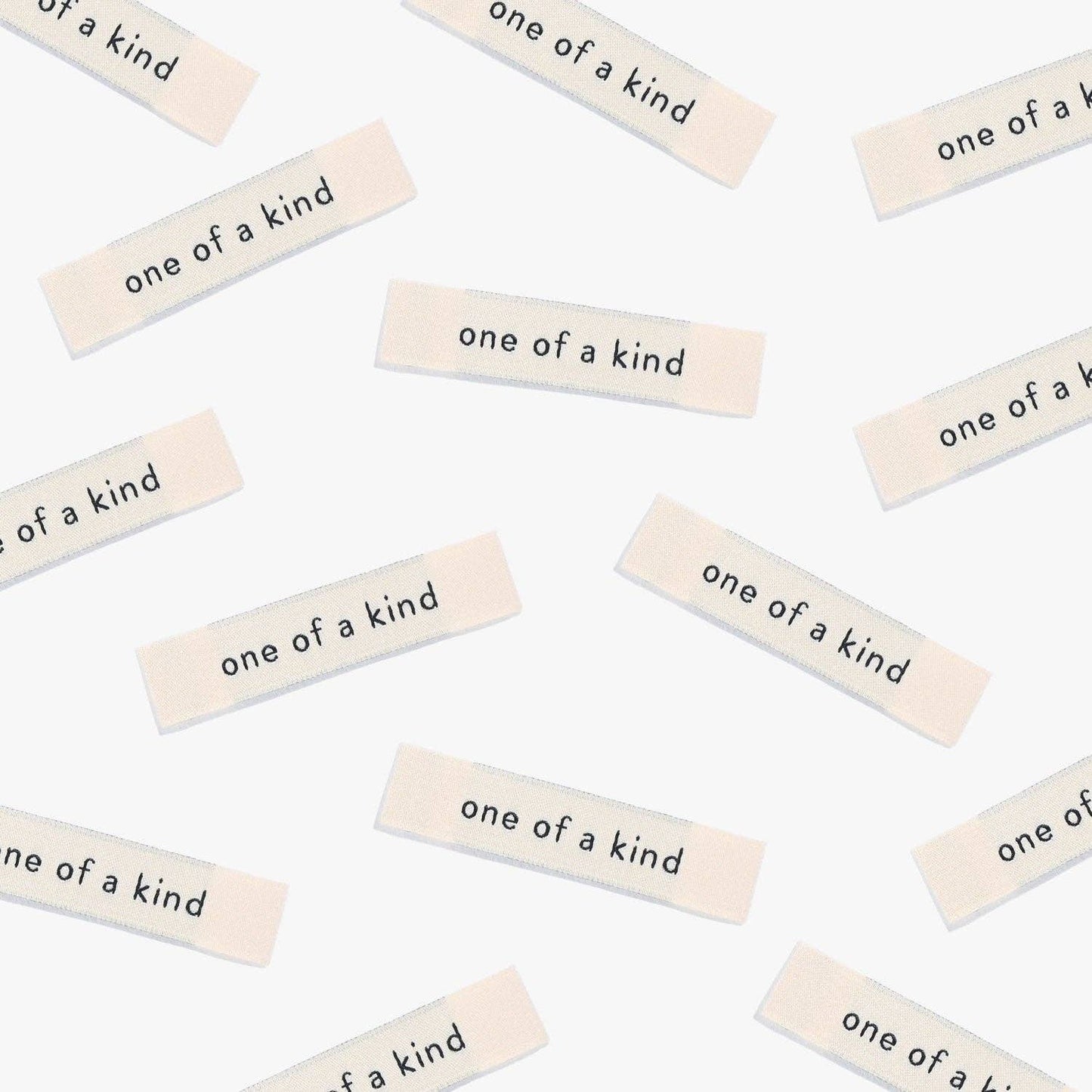 Kuvassa on Kylie & The Machine One of a kind -kangasmerkit (labels).